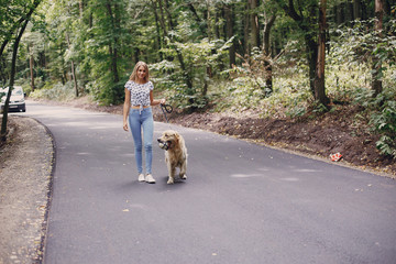 couple walking outdoors with her dog