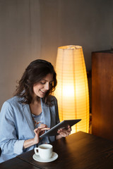 Happy woman using tablet computer.