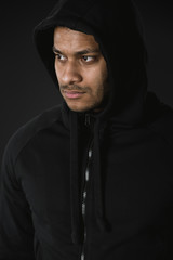 Obraz premium young african american man in zoodie isolated on black