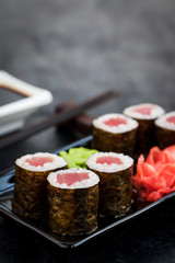 Fresh delicious tuna maki sushi rolls on dark background