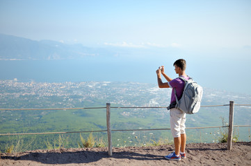 Hiker with backpack on the top of Vesuvius mountain