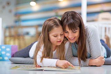 Mother and daughter reading together
