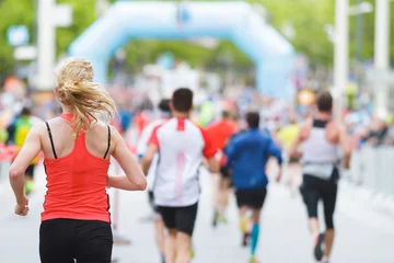 Woman running at marathon at start / finish © TeamDF
