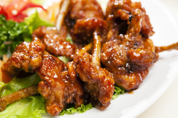 Close-up of deep fried boxing chicken drumettes on white plate