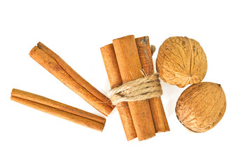 Cinnamon sticks and walnuts isolate on white background