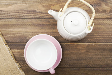 Background of napkin next to ceramic ware on wooden background. Copy space. Horizontal shoot.