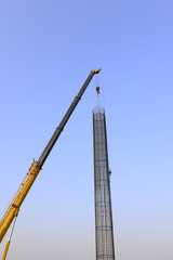 Hoisting steel bars in the construction site