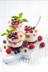 sweet dessert with jam, cream and fresh fruit on white background, vertical