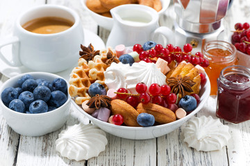sweets, cookies and berries for breakfast