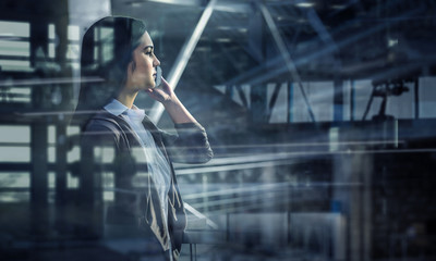 Elegant businesswoman in office interior. Mixed media