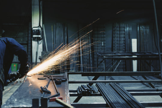Industrial worker at the factory welding closeup