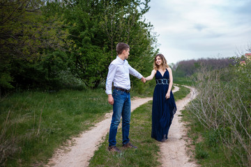 Couple in love walking in the woods holding hands 