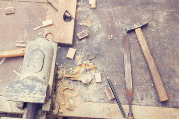 Carpenter's little working tools on a dusty table.