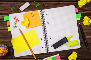 Open notepad with office supplies