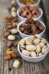 Nuts in a plate on a  wooden table.