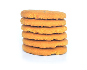Single round ginger biscuits rool with crumbs isolated on white from above.