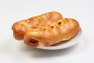 Pancakes roll with sausage on a plate, white background