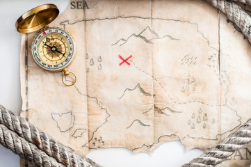 Top view to Fake treasure map with red cross and Marine rope 