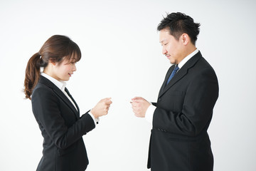 Business persons exchanging business cards