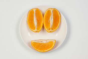 Naklejka na ściany i meble Orange on a plate, cut