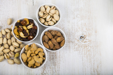 Nuts in a plate on a  wooden table.