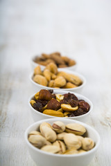 Nuts in a plate on a  wooden table.