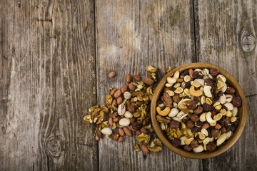 Nuts in a wooden bowl  on a  wooden table.