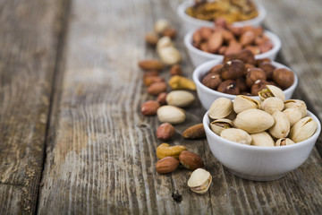 Nuts in a plate on a  wooden table