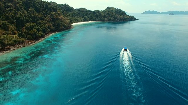 speed  boat running on clear blue sea water of nyaung oo phee island andaman sea myanmar
