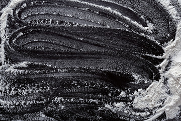 Baking concept on black background, sprinkled flour with copy space