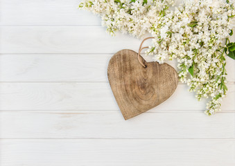 White lilac flowers wooden heart