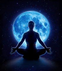 Fototapeta na wymiar Yoga woman in full blue moon and star. Meditation girl sitting in lotus pose under moonlight in dark night sky, Moon original image from NASA.gov