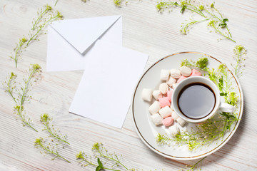 Flowers composition. Cup of coffee, dried flowers and leaves. Top view, flat lay