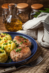 Meatballs served with boiled potatoes.