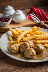 Meatballs with french fries in dill sauce.