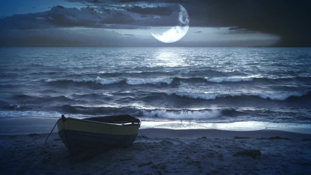 Lonely boat at night with a beautiful big waxing moon above the sea.
