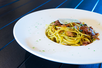 A plate of delicious spaghetti bolognese with meat sauce and fresh basil.