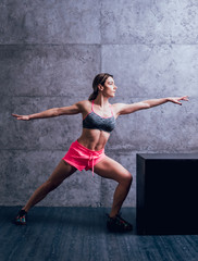 Young beautiful sportswoman doing exercises.