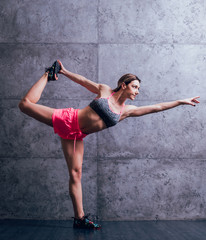 Fototapeta premium Young beautiful sportswoman doing exercises.