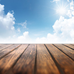 Blue sky with wooden table