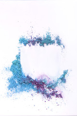 Obraz premium Makeup eyeshadow sprinkled on white background