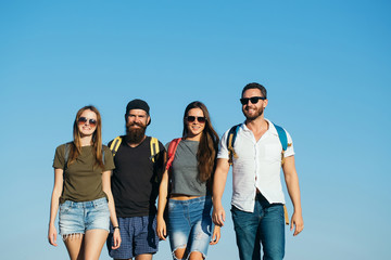 Obraz premium Happy, women and handsome men smiling on blue sky