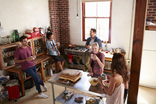 Five Friends Stand Hanging Out In Kitchen, Elevated View