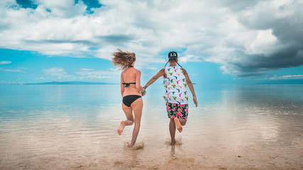Boy and Girl Couple running on a paradise island