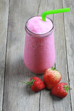 Strawberry Smoothies in Glass on foods table floor.