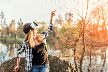 Young girl enjoy virtual reality glasses outdoor