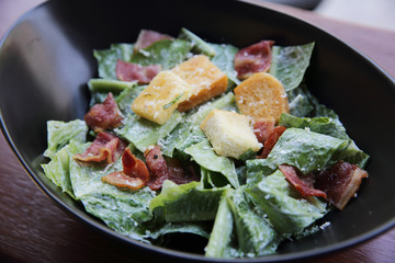 caesar salad on wood background