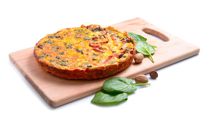 Pie with spinach and ham on the board. Isolated.