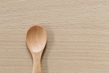 Empty wooden spoon on wood floor.
