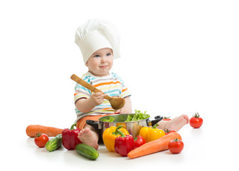 baby chef with healthy food vegetables and pan